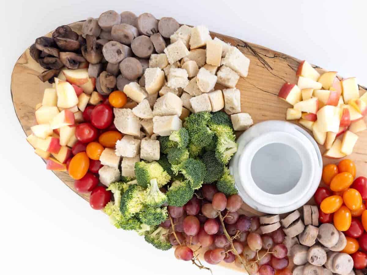 Charcuterie board with vegetables, fruits, and a savory combination
