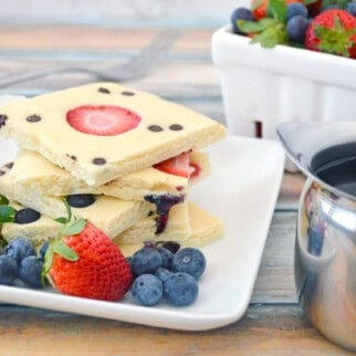 Sheet Pan Pancakes with berries and syrup.