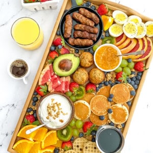 Nutritious breakfast recipes like waffles, eggs, fruit, yogurt, and more are displayed on a tray as a Breakfast Board.