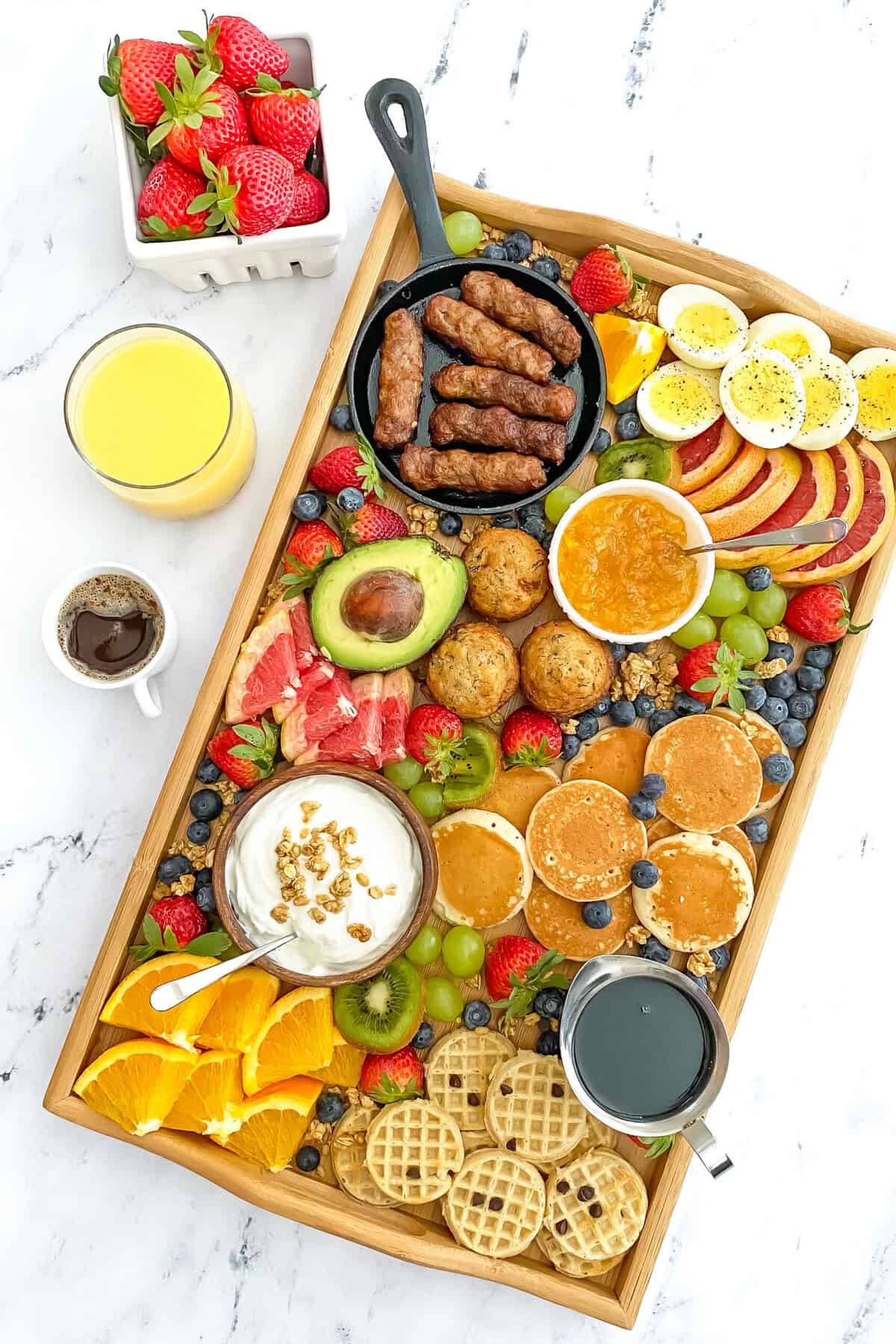 Nutritious breakfast recipes like waffles, eggs, fruit, yogurt, and more are displayed on a tray as a Breakfast Board.