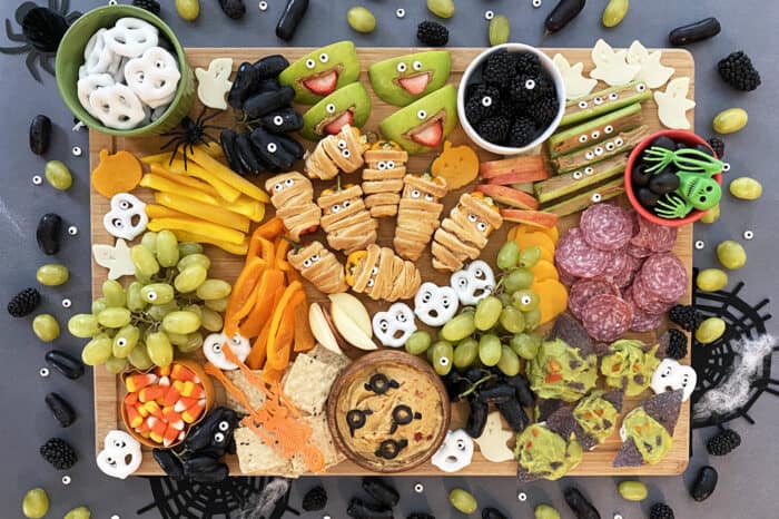 Halloween snack board with fruit, cheese, and spooky treats